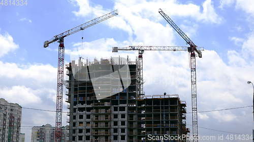 Image of Tower cranes against blue sky, with clouds. Timelapse. UltraHD stock footage