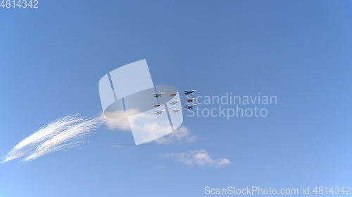 Image of Fighters Su-35 (Flanker-E) and MiG-29 (Fulcrum) lined diamond fly with fireworks fly in sky