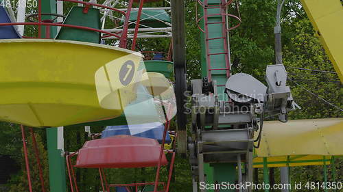 Image of Underside view of a ferris wheel over blue sky.