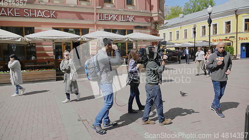 Image of MOSCOW - JUNE 7: The film crew interviews the seller of ice cream on June 7, 2017 in Moscow, Russia. UltraHD stock footage