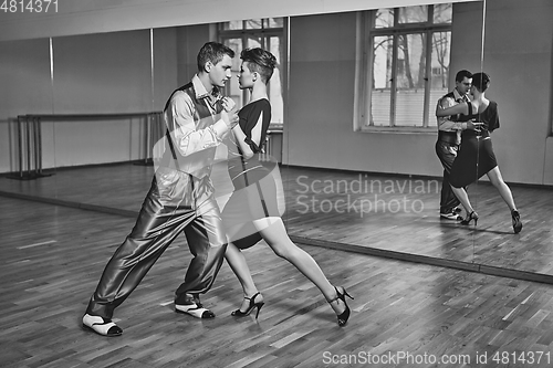 Image of beautiful couple dancing tango