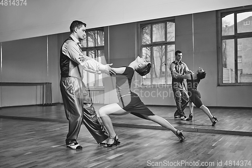 Image of beautiful couple dancing tango