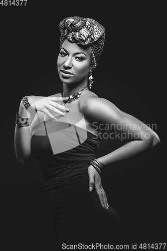 Image of beautiful mulatto young woman with turban on head