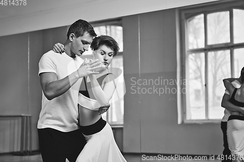 Image of beautiful couple dancing tango