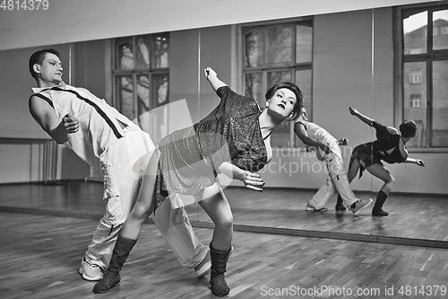 Image of beautiful couple dancing bachata in dance studio