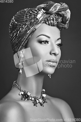 Image of beautiful mulatto young woman with turban on head