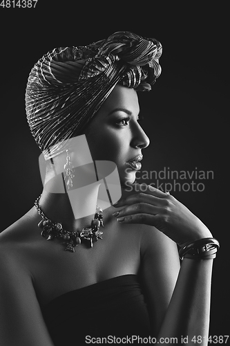 Image of beautiful mulatto young woman with turban on head