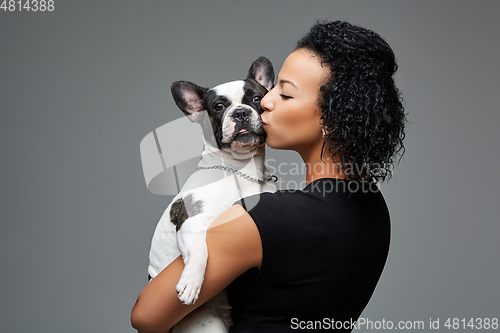 Image of young woman with french bulldog dog