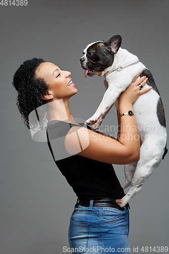 Image of young woman with french bulldog dog