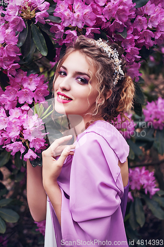 Image of girl in dress in rhododendron garden