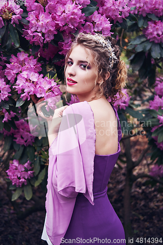 Image of girl in dress in rhododendron garden