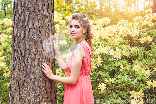 Image of girl in dress in rhododendron garden