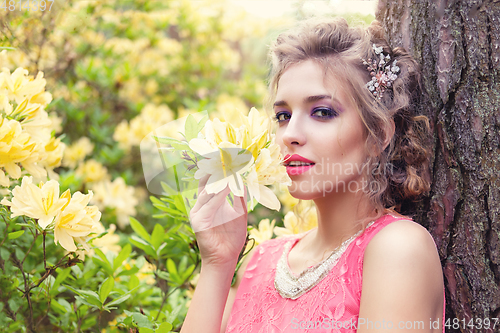 Image of girl in dress in rhododendron garden