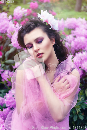 Image of girl in dress in rhododendron garden