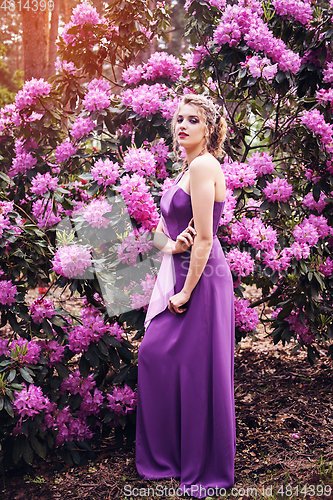 Image of girl in dress in rhododendron garden