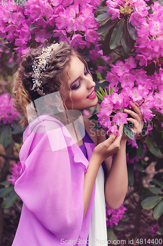 Image of girl in dress in rhododendron garden