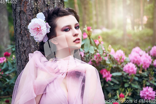 Image of girl in dress in rhododendron garden