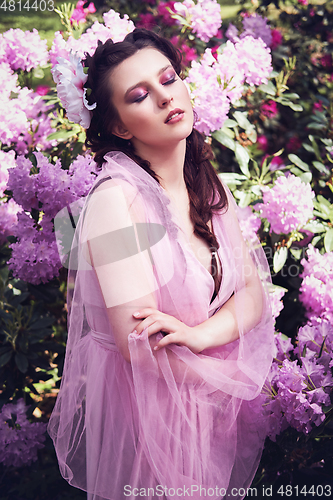 Image of girl in dress in rhododendron garden