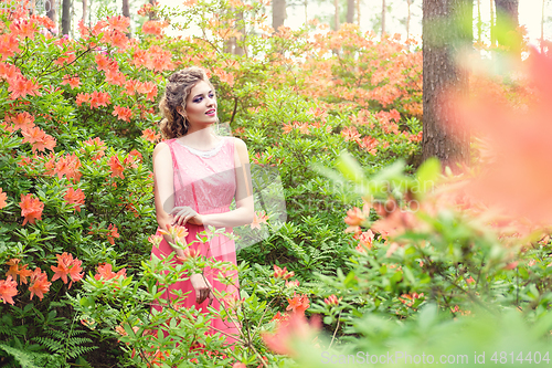 Image of girl in dress in rhododendron garden