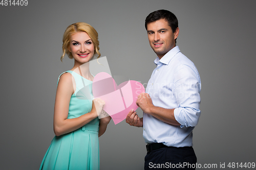 Image of Beautiful couple holding pink heart