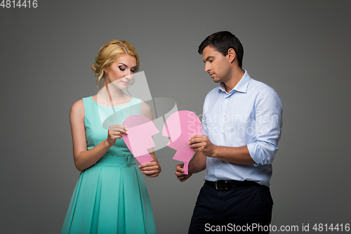 Image of Beautiful couple holding pink broken heart