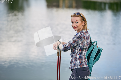 Image of young woman with nordic walk pols