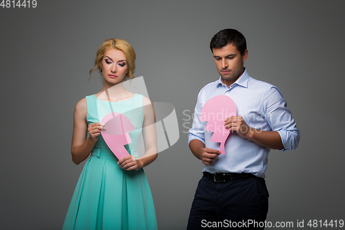 Image of Beautiful couple holding pink broken heart