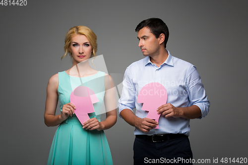 Image of Beautiful couple holding pink broken heart