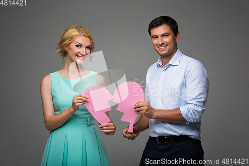 Image of Beautiful couple holding pink broken heart