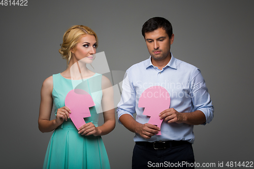 Image of Beautiful couple holding pink broken heart