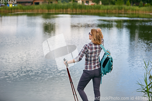 Image of young woman with nordic walk pols