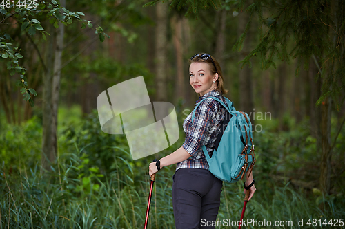 Image of young woman with nordic walk pols