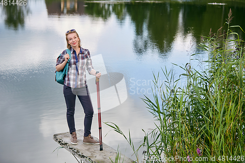 Image of young woman with nordic walk pols