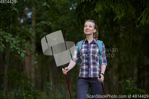 Image of young woman with nordic walk pols