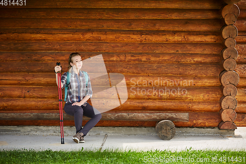 Image of young woman with nordic walk pols