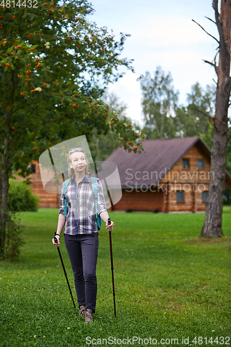 Image of young woman with nordic walk pols