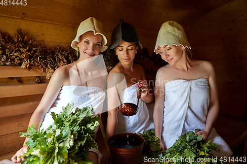 Image of three girls relaxing in sauna