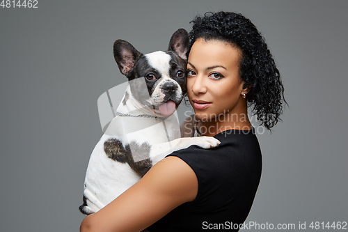 Image of young woman with french bulldog dog