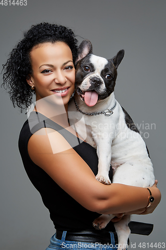 Image of young woman with french bulldog dog