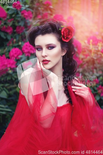 Image of girl in dress in rhododendron garden