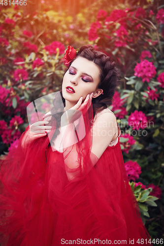 Image of girl in dress in rhododendron garden