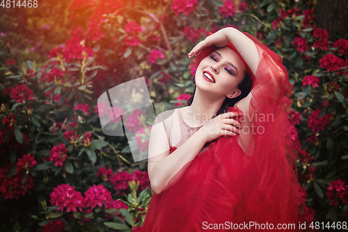 Image of girl in dress in rhododendron garden