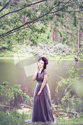 Image of girl in dress in rhododendron garden