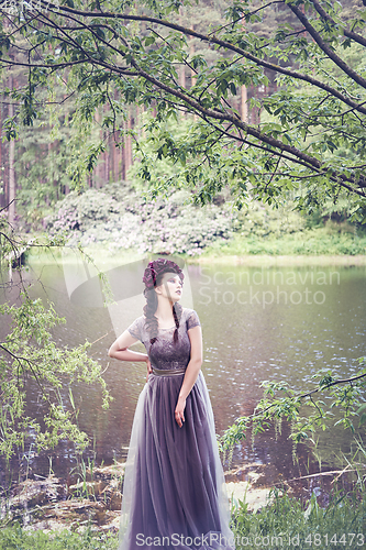 Image of girl in dress in rhododendron garden