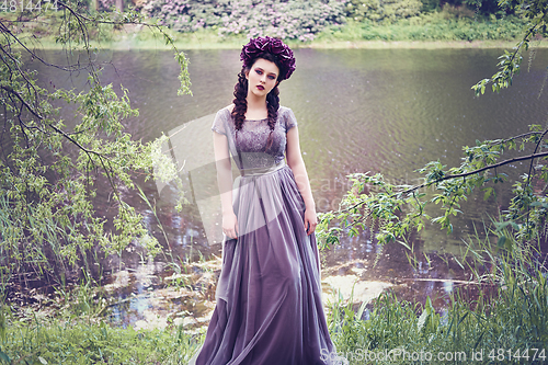 Image of girl in dress in rhododendron garden