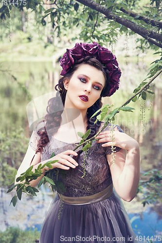 Image of girl in dress in rhododendron garden