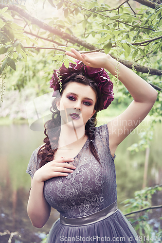 Image of girl in dress in rhododendron garden