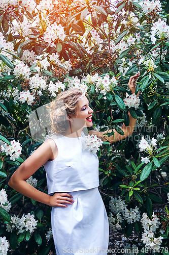 Image of girl in dress in rhododendron garden