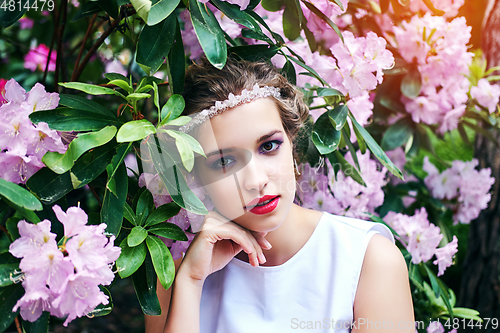 Image of girl in dress in rhododendron garden