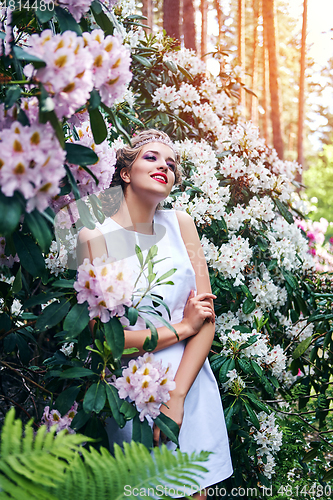 Image of girl in dress in rhododendron garden